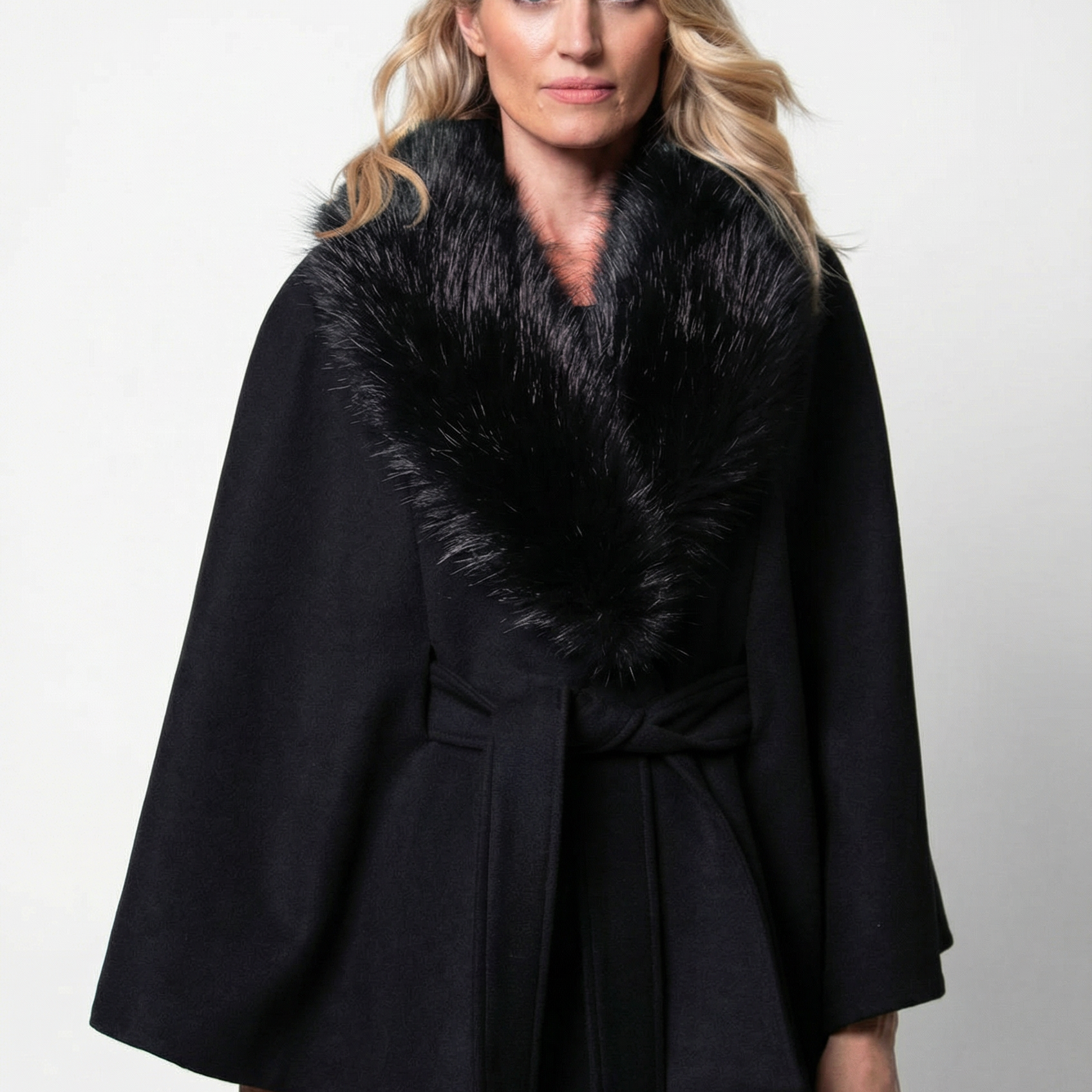 Black wool cape worn over an evening gown for a cold-weather formal event