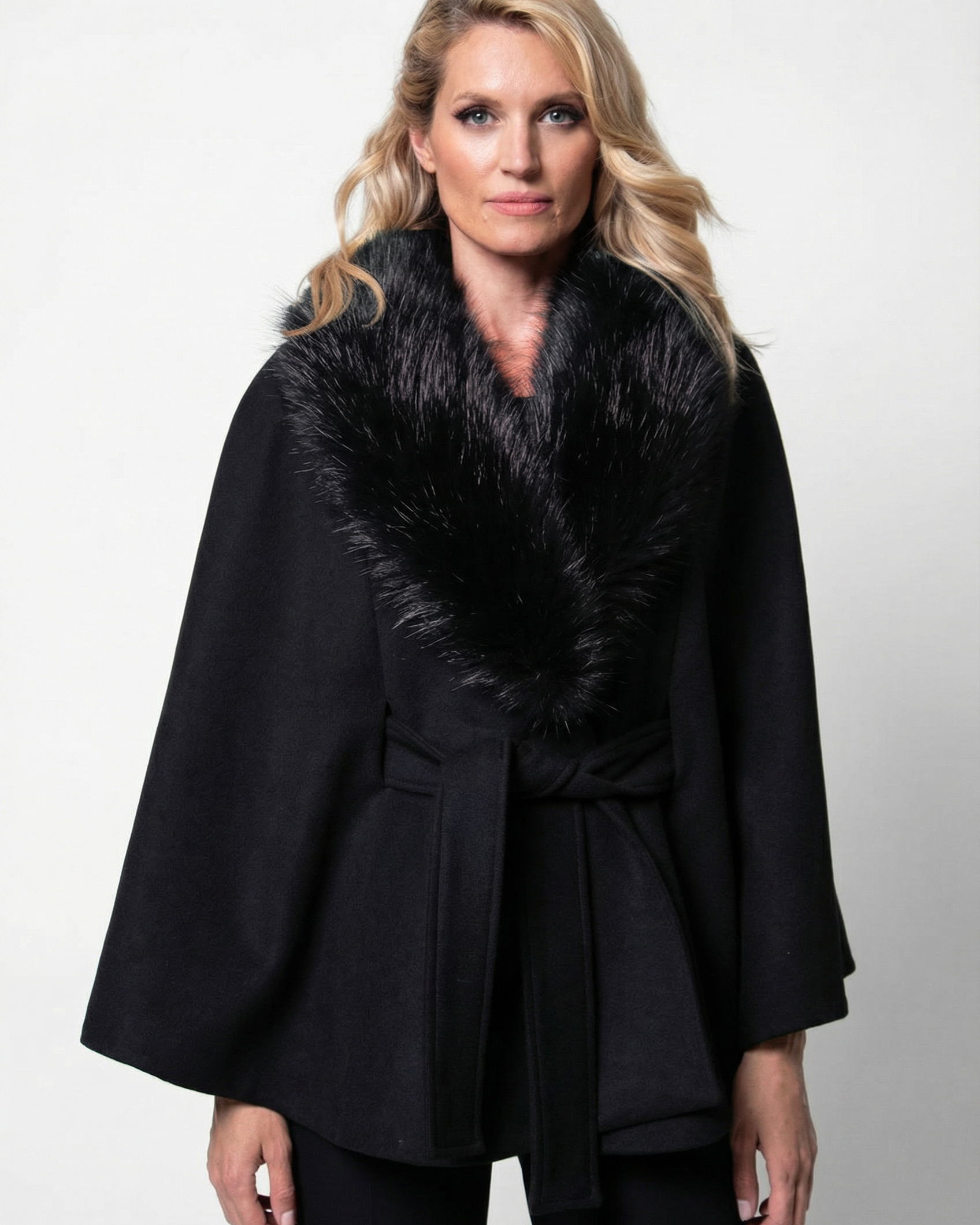 Black wool cape worn over an evening gown for a cold-weather formal event