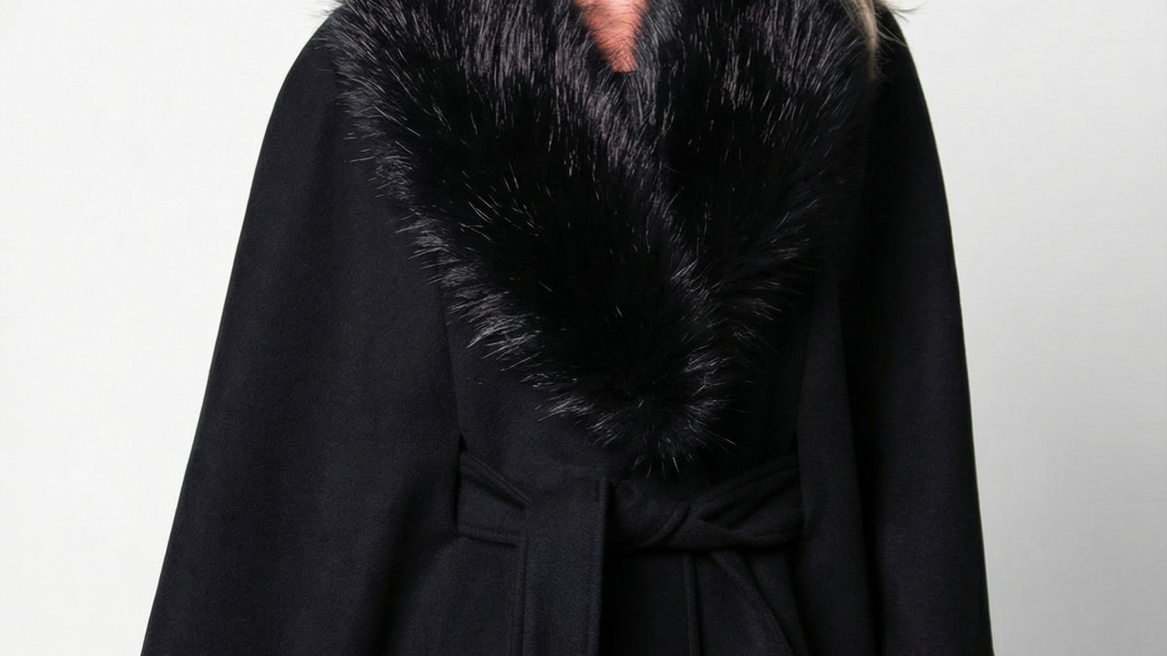 Black wool cape worn over an evening gown for a cold-weather formal event