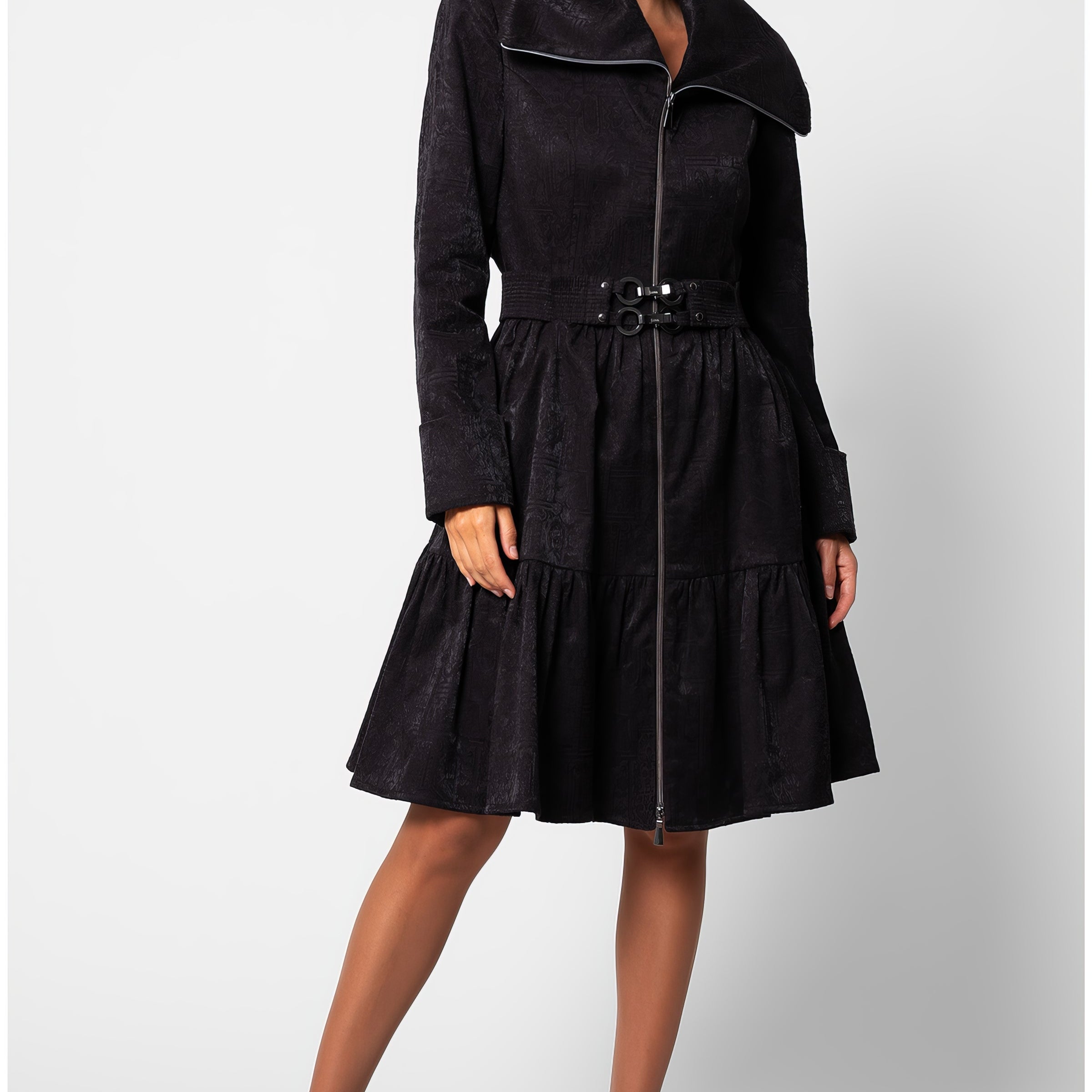 Black short tailored coat, Iris, in a cotton blend with a soft satin finish, wide stand collar, asymmetric zip, buckled belt, and a tiered skirt that ends above the knee