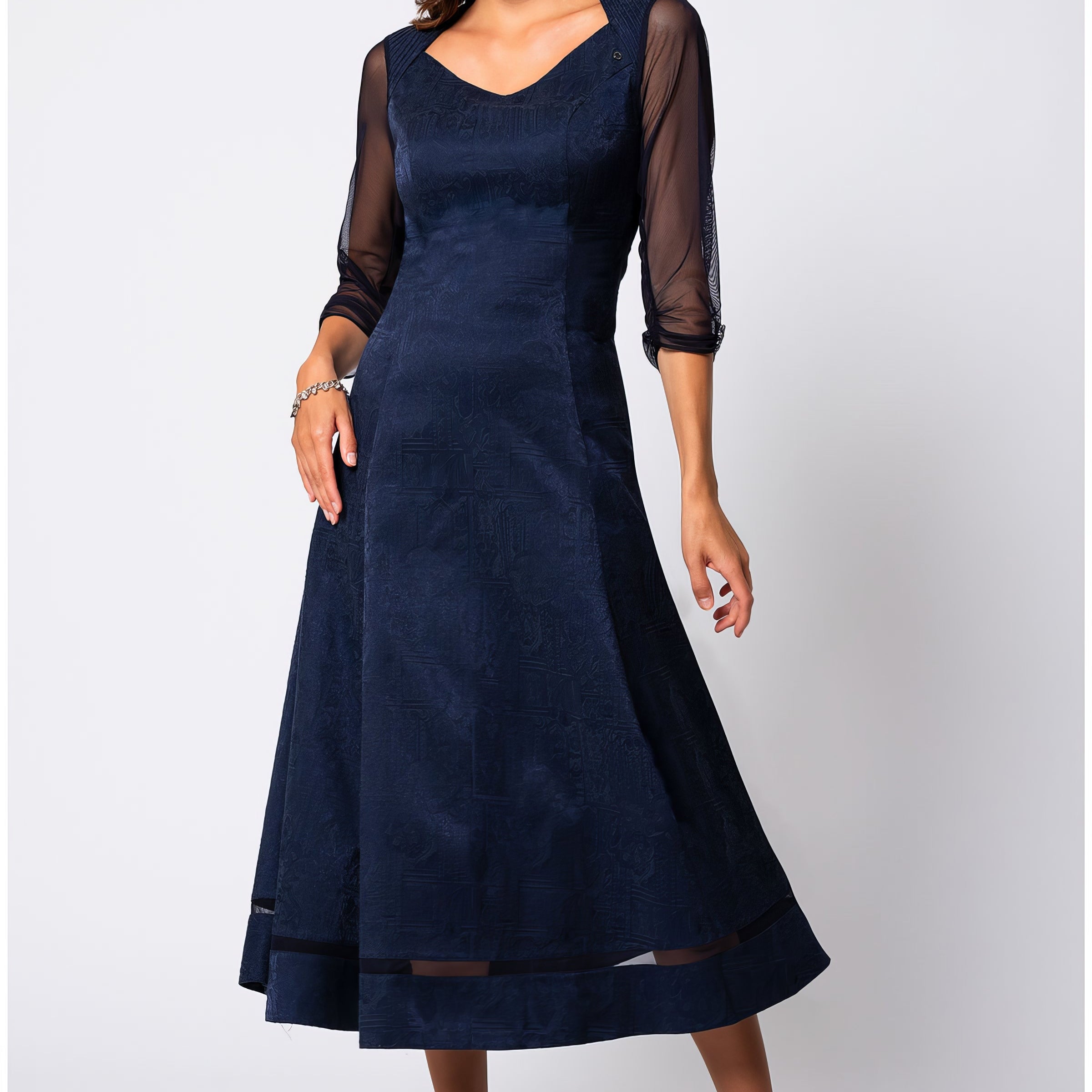 Navy jacquard midi dress with three-quarter sheer sleeves in a softly structured silhouette against a neutral studio background