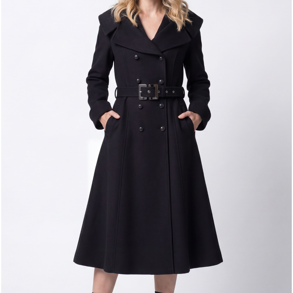 Black wool wrap coat with self-fabric belt and Bemberg lining worn over tailored wide-leg trousers in a neutral studio setting
