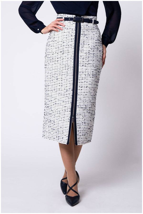 Front view of model in white tweed pencil skirt with navy center zipper and belt