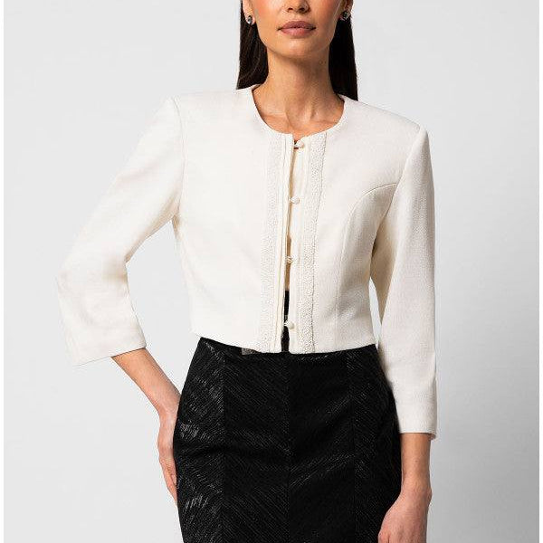 Elegant white cropped tailored blazer jacket with round neckline and front detailing worn with black high-waisted skirt