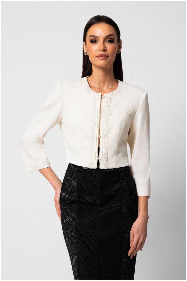 Elegant white cropped tailored blazer jacket with round neckline and front detailing worn with black high-waisted skirt