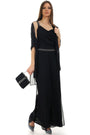 structured handbag woman in elegant black jumpsuit holding Bag Klara evening purse with metallic handle and beaded embellishment