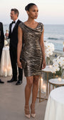 Woman wears the bronze metallic cocktail dress at an oceanfront formal reception with champagne and candlelight