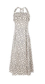 Satin white elegant midi dress with black polka dots, halter neck, and flowing skirt for elegant occasions.