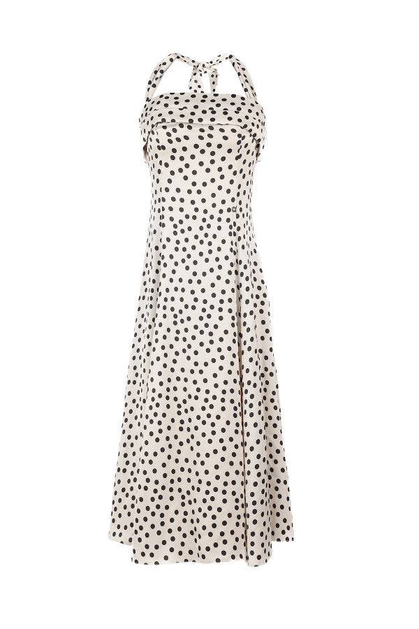 Satin white elegant midi dress with black polka dots, halter neck, and flowing skirt for elegant occasions.