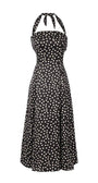lack elegant midi dress with white polka dots, halter neck, and flattering corset-style bodice for elegant occasions.
