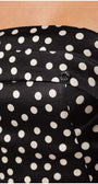 Close-up of black elegant midi dress satin fabric with white polka dots on the strapless corset bodice of the Melissa midi dress
