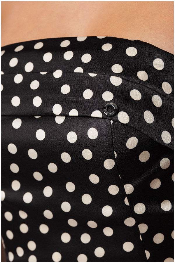 Close-up of black elegant midi dress satin fabric with white polka dots on the strapless corset bodice of the Melissa midi dress