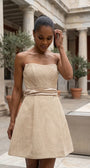 Melisa beige strapless mini corset dress with flared skirt in a refined courtyard setting.