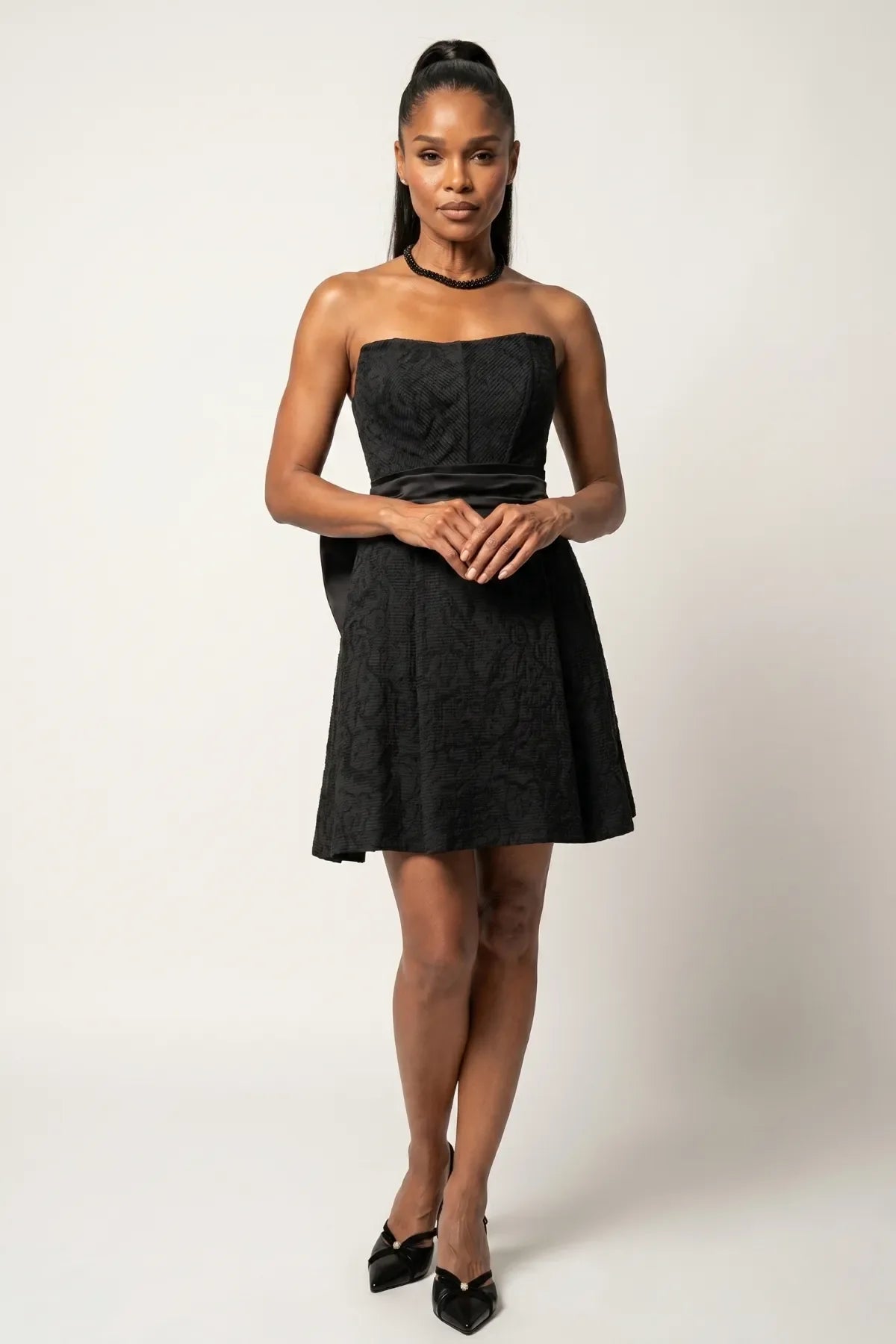 Front model view of Melisa black strapless corset mini dress with structured bodice and flared skirt.