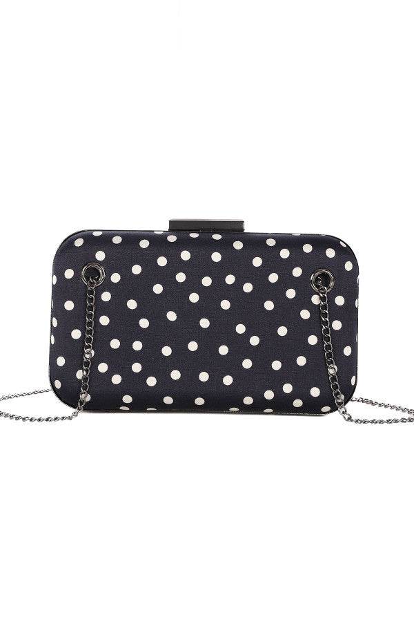 Black evening structured shoulder bag with white polka dots and detachable silver chain strap, elegant and chic design.