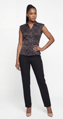 Woman wearing a black and white patterned sleeveless blouse with black pants on a white background