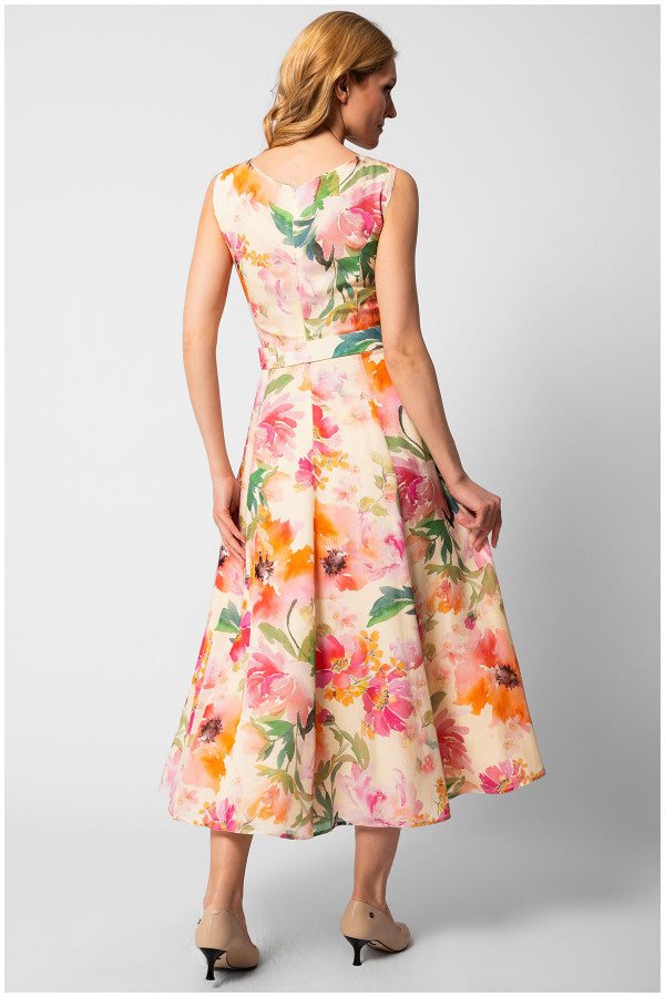 Woman wearing sleeveless floral elegant midi dress with belted waist and flowing skirt, photographed from the back