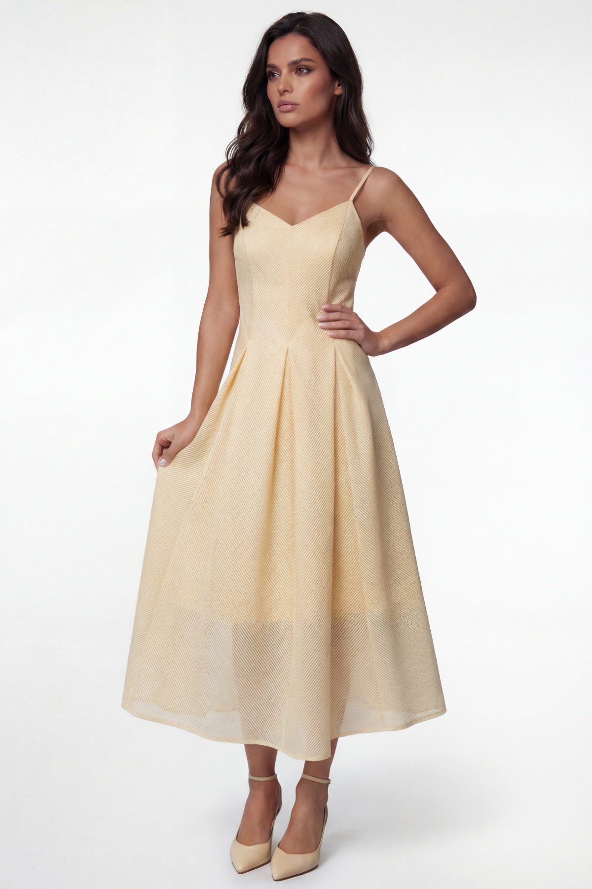 Woman wearing a light yellow dress on a white background