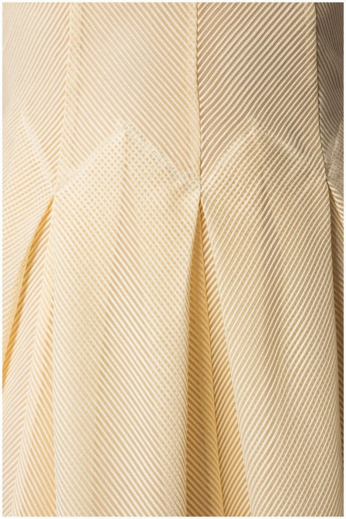 Ivory Midi Dress, Nela. Close up of the pleated ivory fabric.