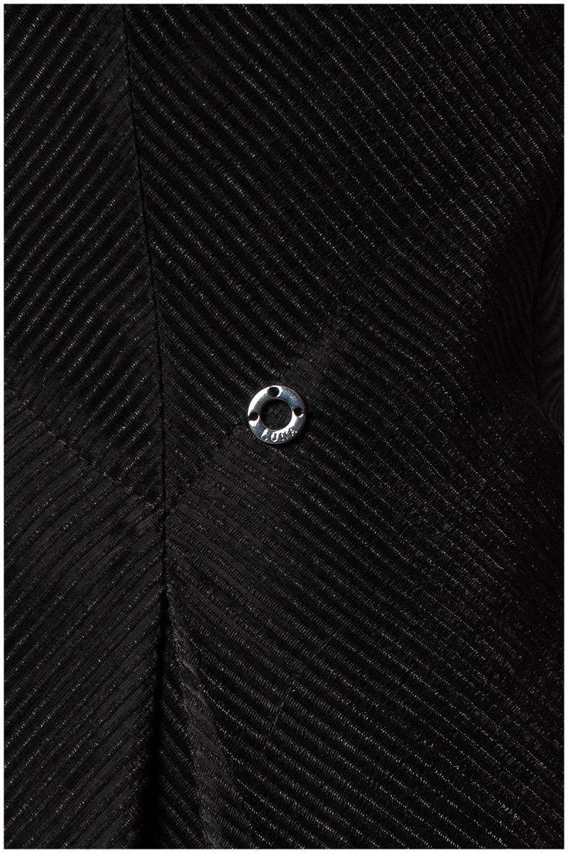 Close-up of a black textured fabric with a button