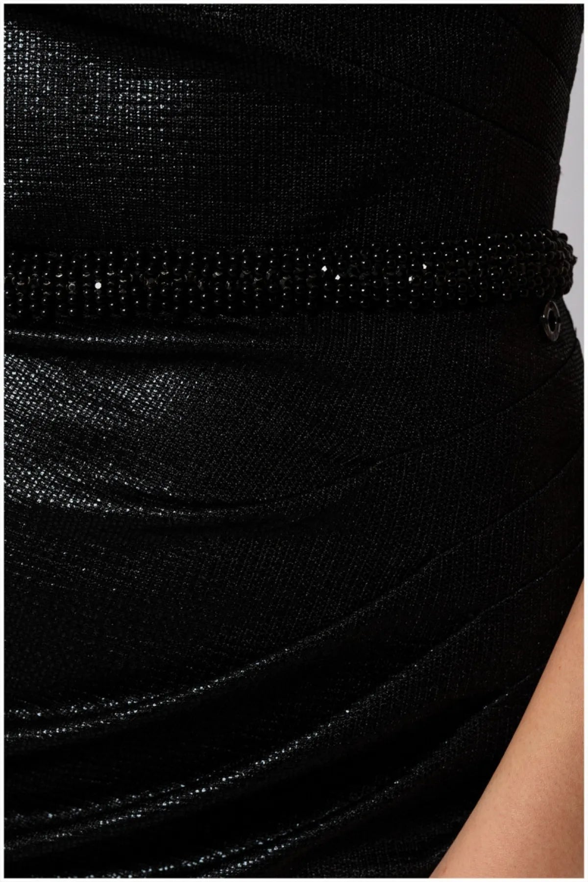 Faceted black beaded waist band detail over coated polyester knit with quiet metallic finish