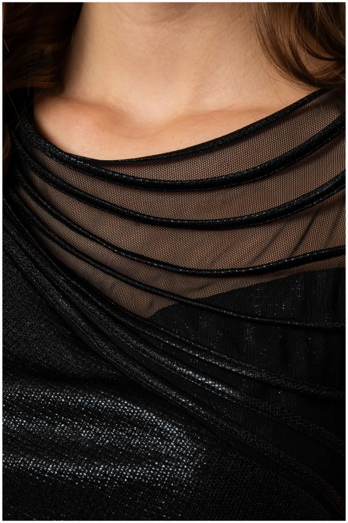 Close-up of sheer black mesh neckline with concentric layered satin piping bands