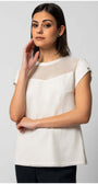 Woman wearing Aria Short-Sleeve Blouse in White with mesh detail and button accents on sleeves against gray background