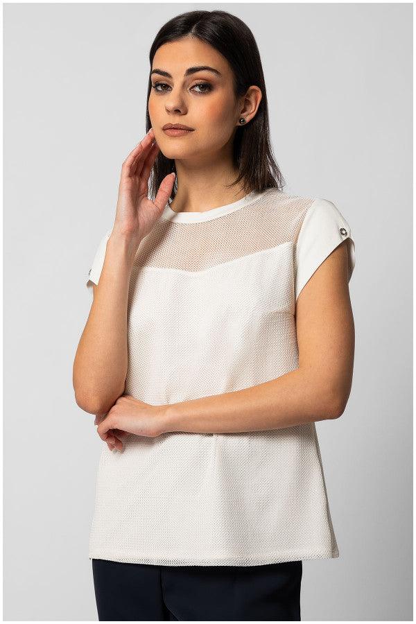 Woman wearing white short-sleeve TOP ARIA blouse with sheer neckline panel and textured finish