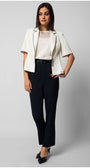 woman wearing white short-sleeve Aria top with sheer neckline and white blazer paired with black trousers and black heels