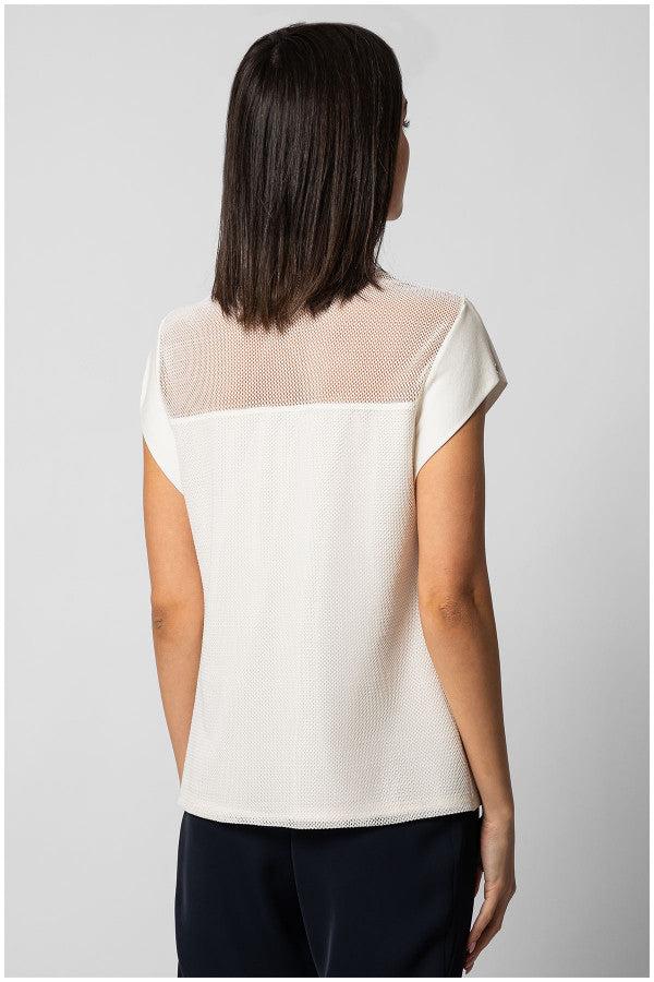 Woman wearing white Top Aria blouse with sheer paneling on back and short sleeves