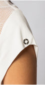 Close-up of white TOP ARIA short-sleeve blouse with textured fabric and sheer panel detailing on shoulder.