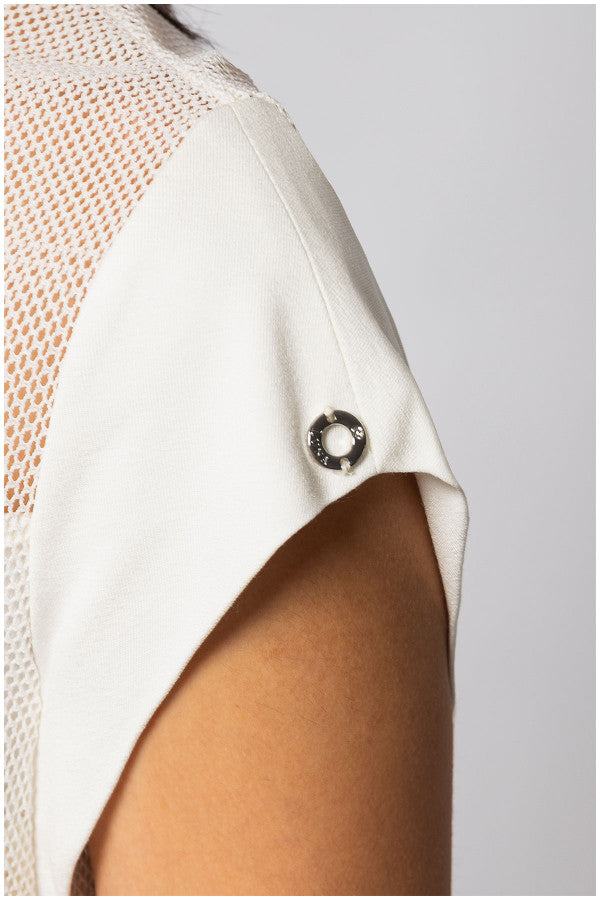 Close-up of white TOP ARIA short-sleeve blouse with textured fabric and sheer panel detailing on shoulder.