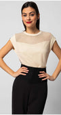Woman wearing a cream womens short sleeve blouse with sheer paneling at the neckline paired with black pants