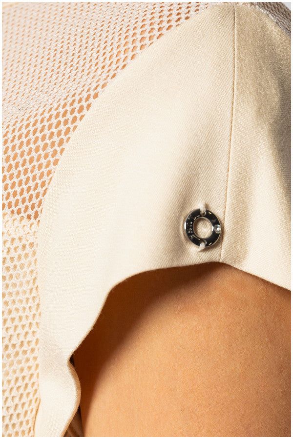 Close-up of elegant womens short sleeve blouse in beige with textured and sheer panel detailing