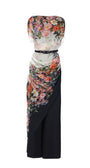 Two-layer floral-overall-tina-two-layer with draped top with belted waist over sleek navy flared trousers in the Tina Overall design.