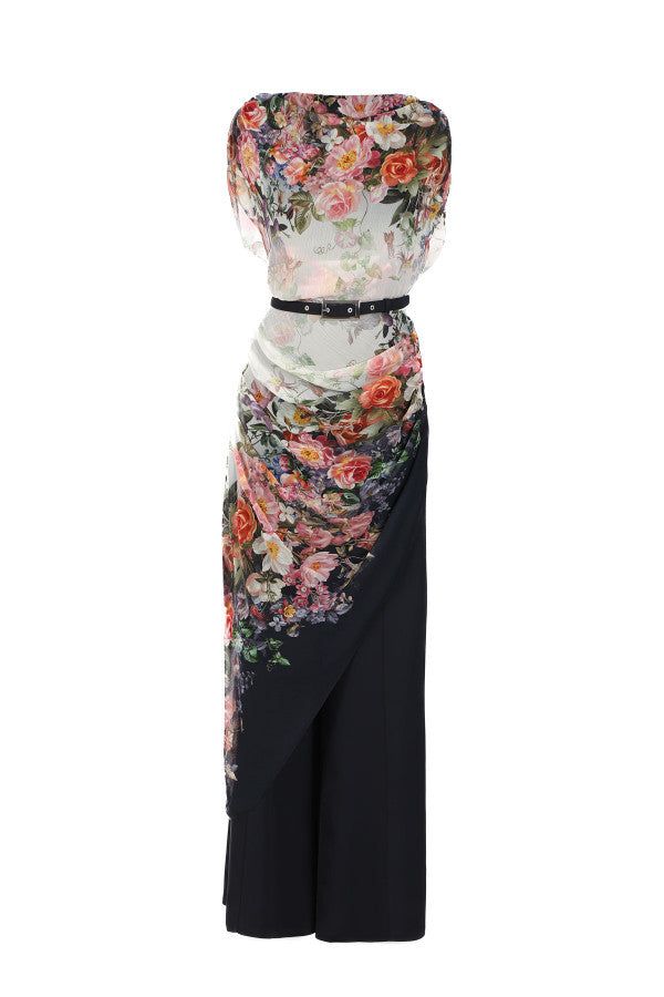 Two-layer floral-overall-tina-two-layer with draped top with belted waist over sleek navy flared trousers in the Tina Overall design.