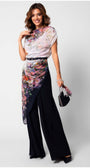 Woman wearing Tina Two Layer Overalls with floral lace top and layered silhouette, styled with handbag and heels