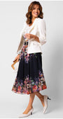 Woman wearing a flowing elegant midi dress Julia Dress with a statement belt and white tailored jacket, carrying a handbag