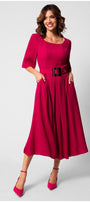 Woman wearing a vibrant elegant midi dress with square neckline, short sleeves, pleated skirt, and wide belt with sculpted buckle