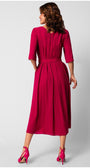 Woman wearing a fitted elegant midi dress in vibrant pink with half sleeves, pleated skirt, and matching high heels viewed from the back.