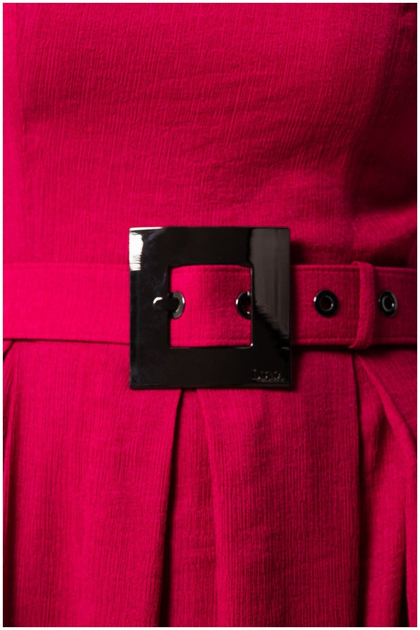 Close-up of the bold sculpted belt buckle on the vibrant elegant midi dress Charlotte by Luna.