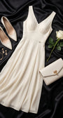 Rebeka ivory gown styled flat with white pumps, clutch, gold jewelry and a white rose