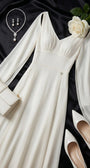 Rebeka ivory gown styled on black satin with white heels, clutch, pearl jewelry and a white rose