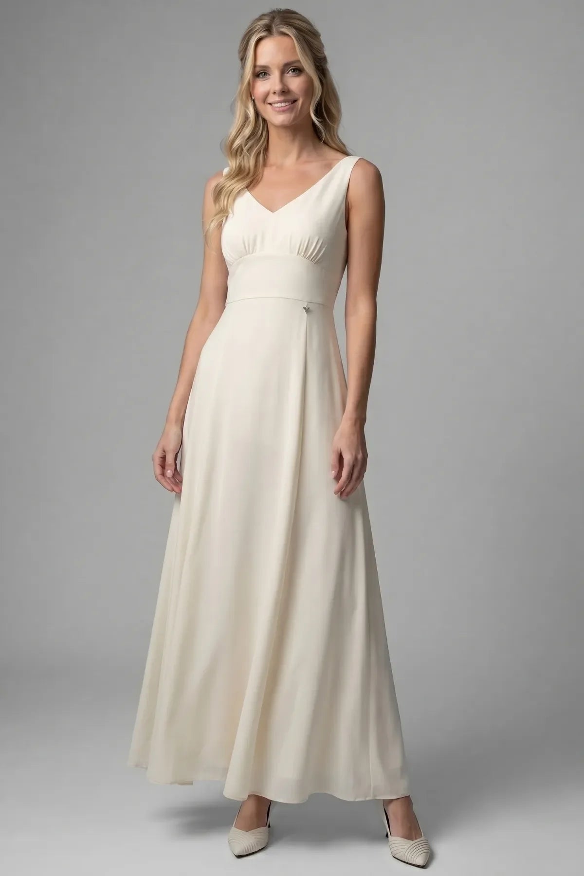 Front view of the Rebeka ivory gown worn sleeveless with the cape sleeves removed