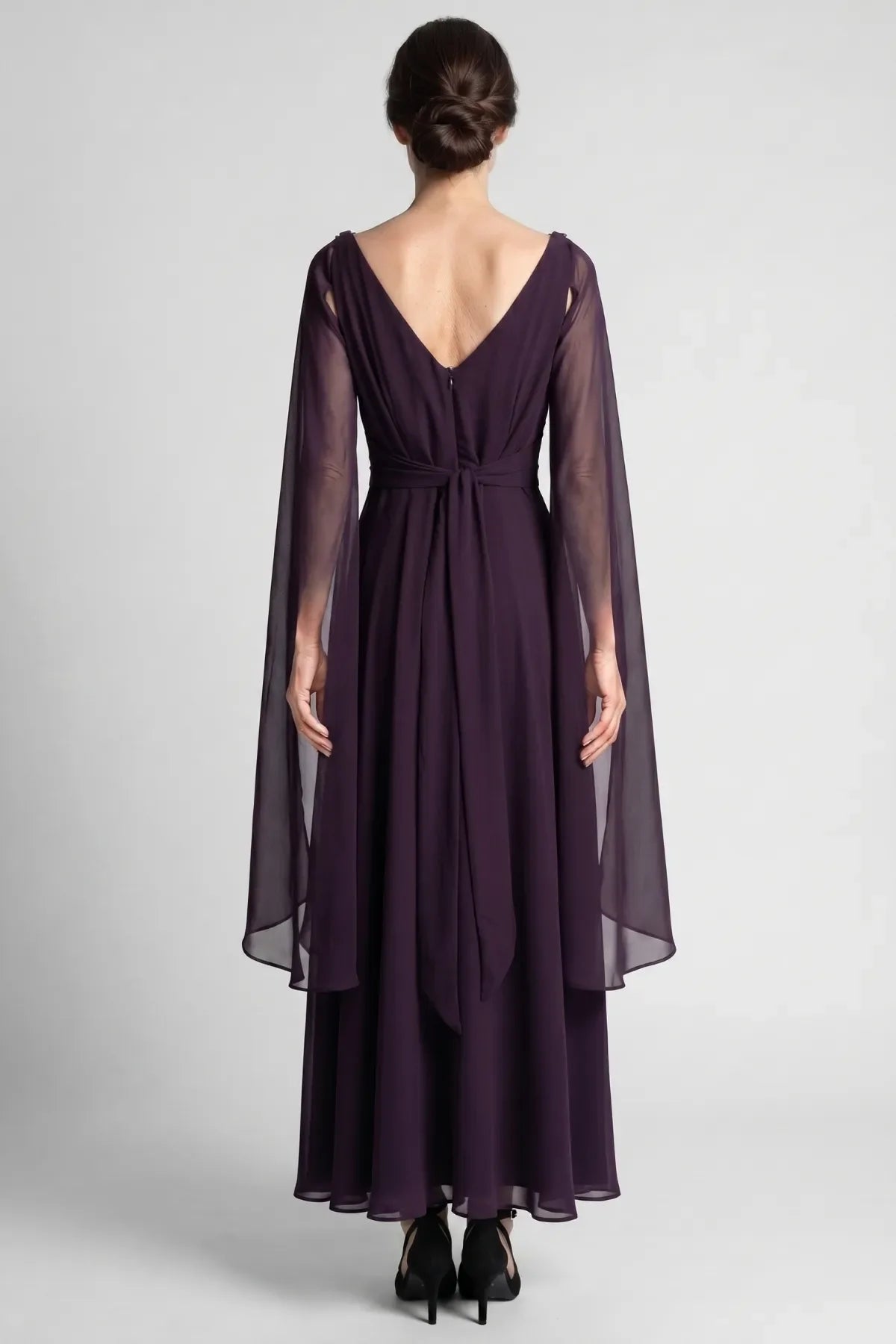 Back of the Rebeka plum gown with V back, hidden zipper, sash tie and long sheer drape sleeves