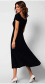 Woman smiling wearing Rina Elegant Midi Dress in Black with short sleeves and flowing skirt in studio setting