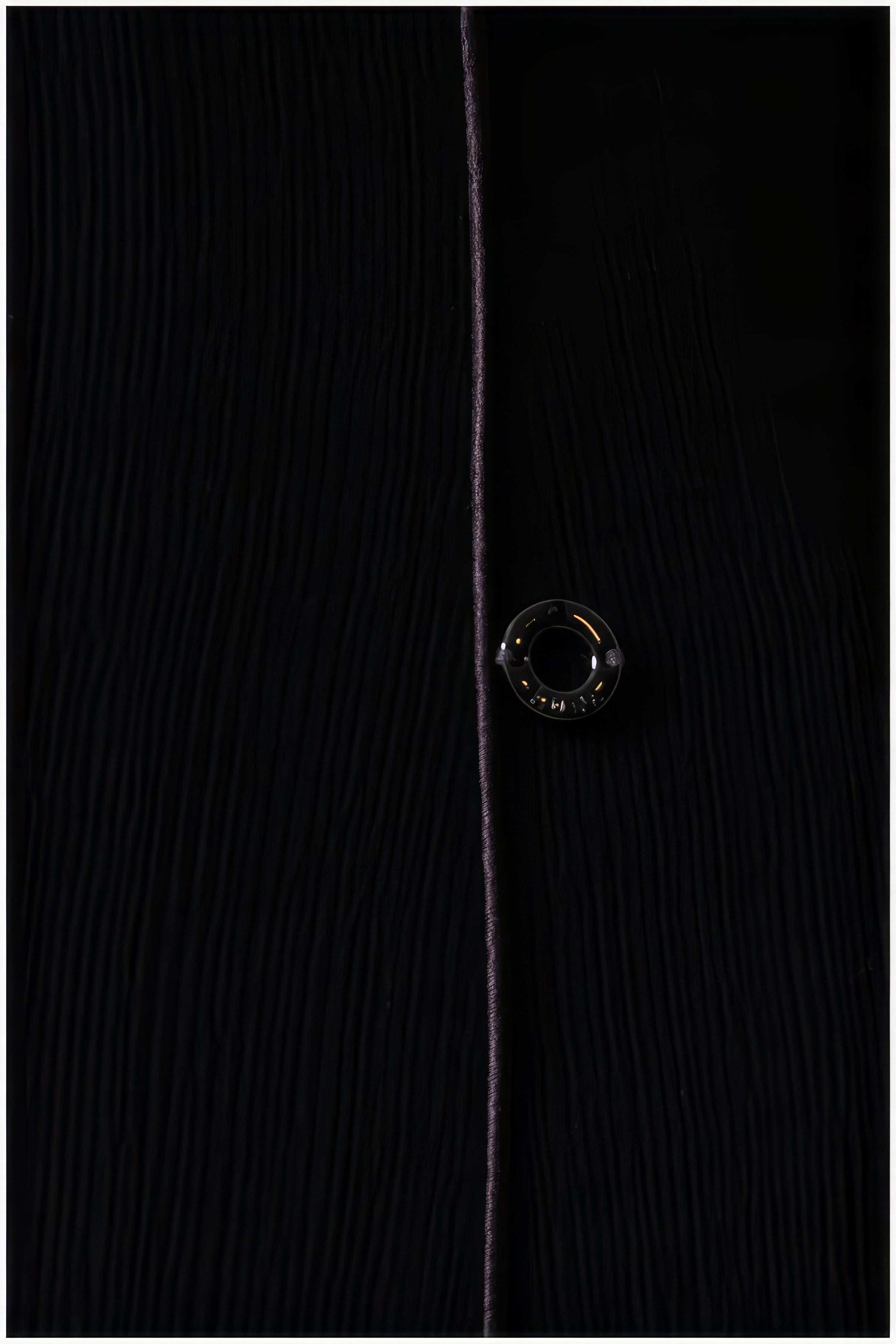Close-up of textured fabric and button detail on the Rina Elegant Midi Dress in Black from Luna Fashion House