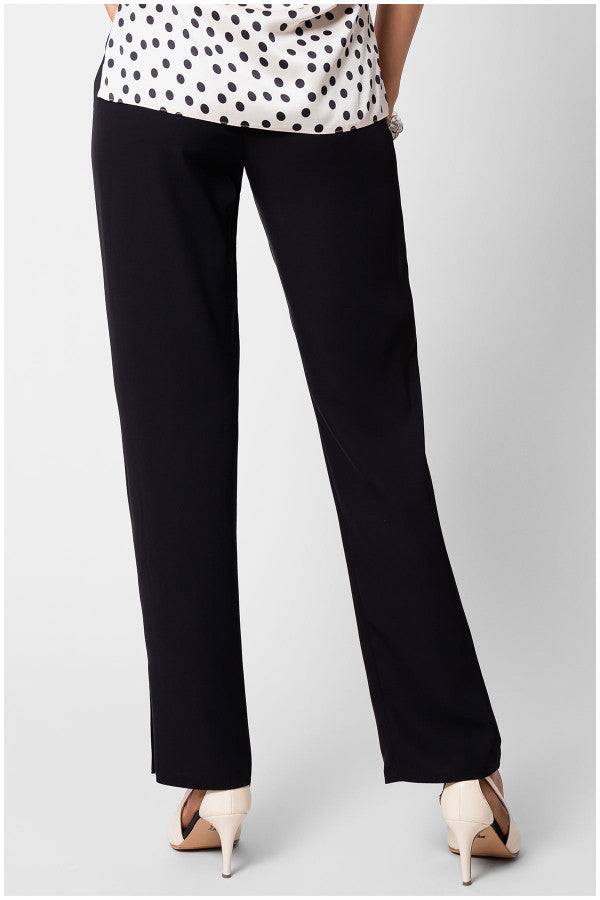 Black Women Travel Pants Teodora Pants with straight-leg fit in soft stretch fabric, styled with beige heels and polka dot top.