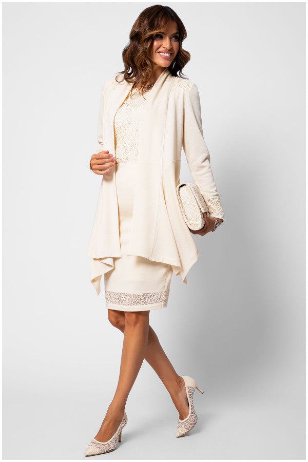 Woman wearing Jody Tailored Cardigan in Ivory with elegant lace details, styled with matching skirt and accessories