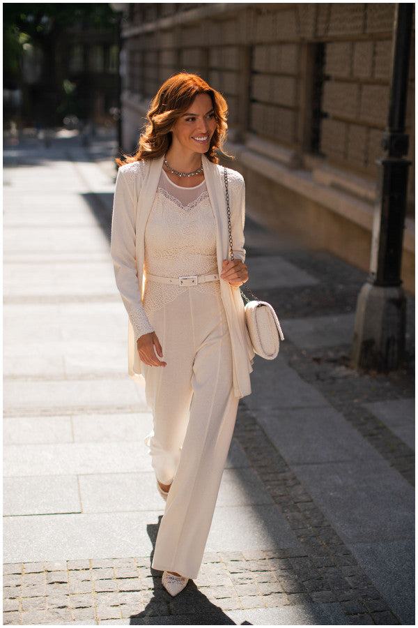 Woman walking outdoors wearing Jody Tailored Cardigan in Ivory styled with matching high-waist pants and lace top